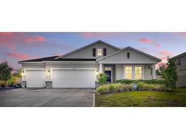 Charming single-story home with a three-car garage and well-manicured lawn at dusk at 485 Halter Dr, Apopka, FL 32712