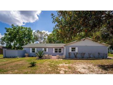 Charming single story home with a well-manicured lawn and a lovely light blue painted facade at 8198 Se 164Th Pl, Summerfield, FL 34491