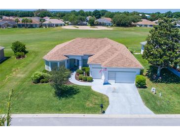 Charming home with a well-maintained lawn, landscaping and a view of the golf course at 11702 Se 173Rd Lane Rd, Summerfield, FL 34491