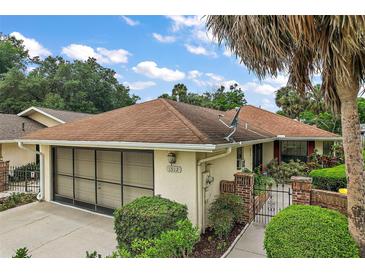 Charming single-story home featuring a well-manicured lawn, attached garage and welcoming curb appeal at 1512 S Pointe Dr, Leesburg, FL 34748