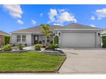 Charming single-story home with a well-manicured lawn and a two car garage at 2170 Biller Cir, The Villages, FL 32163
