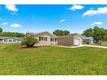 Charming single-story home with a well-manicured lawn and a cozy, inviting exterior at 9645 Se 173Rd Pl, Summerfield, FL 34491