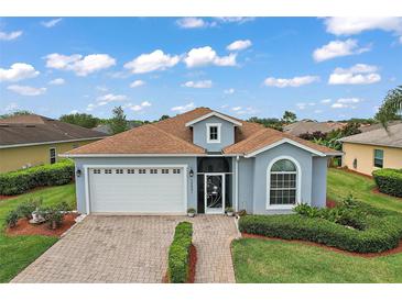 Charming one-story home with a well-manicured lawn and welcoming curb appeal at 10021 Lake Miona Way, Oxford, FL 34484