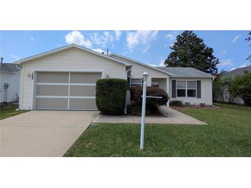 Charming single-story home featuring a well-maintained lawn and attached one-car garage at 17930 Se 83Rd Melody Ave, The Villages, FL 32162