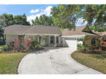 Charming single-story home boasting a circular driveway and meticulously manicured landscaping at 1860 Park Forest Blvd, Mount Dora, FL 32757