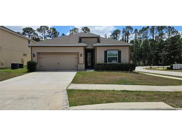 Charming single-Gathering home with a well-maintained lawn and an attached two-car garage at 2129 Amor Way, Leesburg, FL 34748