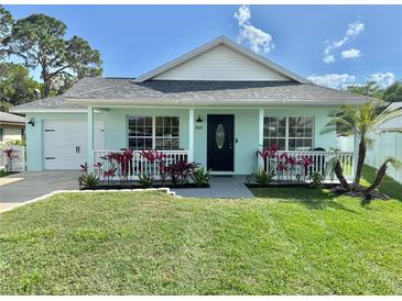 Charming single-story home featuring a cozy front porch and well-manicured lawn at 33635 Jeffery Ct, Leesburg, FL 34788