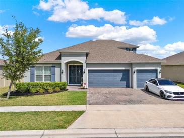 Beautiful single Gathering home with a three car garage, landscaped yard and curb appeal at 533 Avila Pl, Howey In The Hills, FL 34737