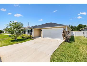 Charming single-story home with a two-car garage and a well-maintained lawn at 1409 Gatlin Pl, The Villages, FL 32163