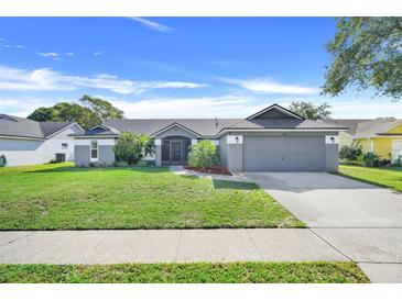 Charming single Gathering home with manicured lawn, mature landscaping, and two car garage at 1761 Country Terrace Ln, Apopka, FL 32703