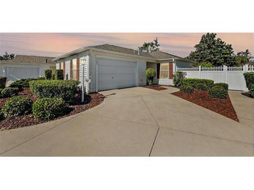 Charming one-story home with a well-maintained lawn and a two-car garage at 17800 Se 91St Gaylark Ave, The Villages, FL 32162