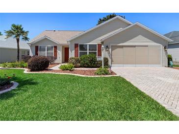 Charming single story home with a lush green lawn and manicured landscaping at 3049 Saint Thomas Ln, The Villages, FL 32162