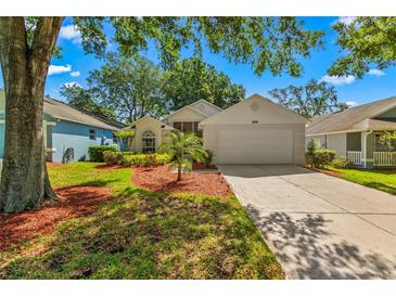 Charming single Gathering home with a well-manicured lawn, mature trees, and a two car garage at 3603 Westerham Dr, Clermont, FL 34711