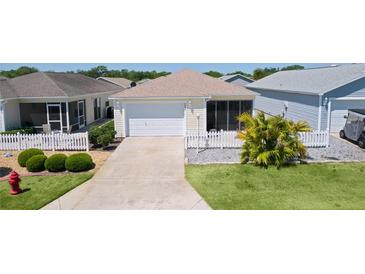 Charming single Gathering home with a two-car garage, well-kept lawn, and cozy front screened in porch at 3756 Viscaya Ct, The Villages, FL 32163