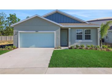 Charming single-Gathering home featuring a well-manicured lawn and attached two-car garage, offering suburban appeal at 5027 Abigail Dr, Lake Wales, FL 33859