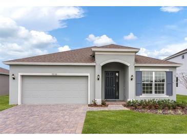 Charming one-story home with a brick paver driveway, well manicured lawn and blue shutters at 5043 Abigail Dr, Lake Wales, FL 33859