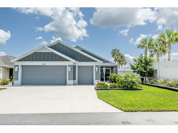Charming single story home featuring a two-car garage, landscaped yard, and welcoming curb appeal at 5325 Zisa Ct, The Villages, FL 32163
