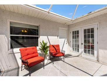 Charming patio area featuring comfortable seating, offering a relaxing outdoor space with privacy at 1037 Willow Dr, Leesburg, FL 34748