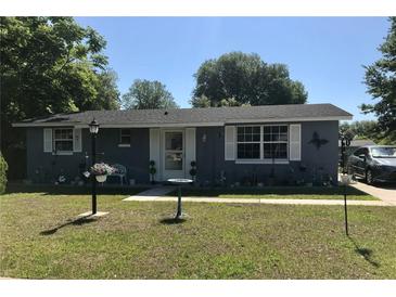 Charming single-story home with blue siding, white trim, and a well-manicured front yard at 14657 Sw 41St Ave, Ocala, FL 34473