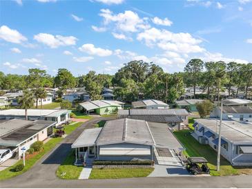 An aerial view shows this desirable home in a quiet neighborhood with mature landscaping and well-maintained surroundings at 150 Hickory Ln, Eustis, FL 32726