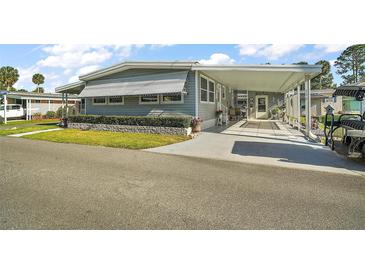 Single-story home with a covered entrance and manicured lawn at 150 Hickory Ln, Eustis, FL 32726