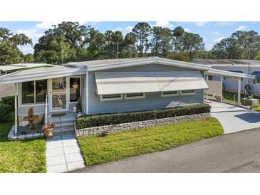 Well maintained single-story home with a manicured lawn and front porch at 150 Hickory Ln, Eustis, FL 32726