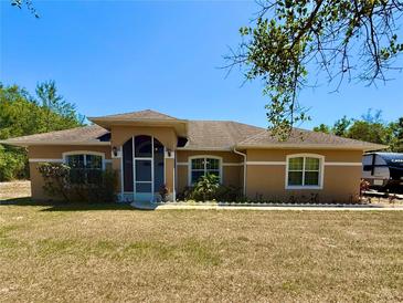 Charming single-story home featuring a screened porch and well-maintained landscaping in a quiet neighborhood at 31728 Nutmeg Ave, Eustis, FL 32736