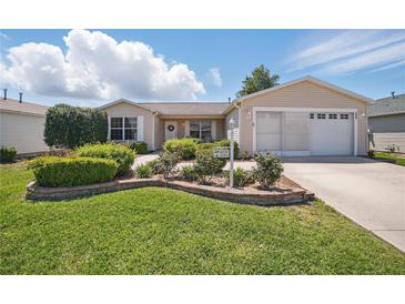 Charming single-story home featuring well-maintained landscaping, a two-car garage, and inviting curb appeal at 3294 Shelby St, The Villages, FL 32162
