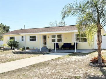 Inviting single-story home featuring a covered front porch and well-maintained landscaping at 33415 Picciola Dr, Fruitland Park, FL 34731