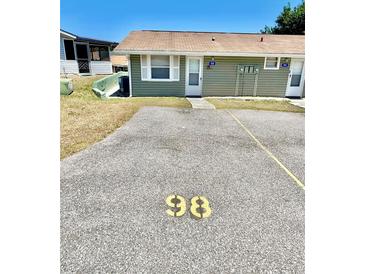 A cozy, single-story exterior with parking space in front of the unit, offering convenient access at 10301 Us Highway 27 # 98, Clermont, FL 34711