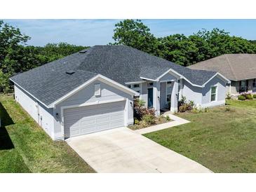 Well-maintained single-Gathering home with a two-car garage, landscaped front yard and a modern roof at 1922 Angel Fish Loop, Leesburg, FL 34748
