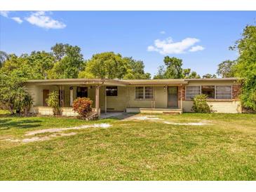 Charming single-story home with a covered porch and well-maintained lawn, perfect for relaxing outdoors at 2928 Delaney St, Orlando, FL 32806