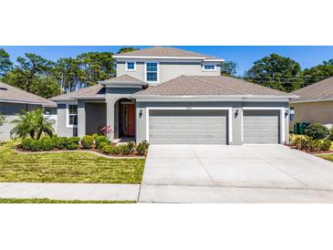 Charming two-story home features a two car garage, well-manicured lawn and tasteful landscaping at 3002 Bethpage Loop, Mount Dora, FL 32757