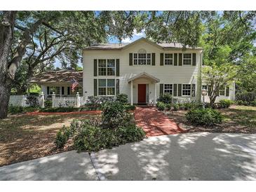 Charming two-story home featuring a brick walkway and lush landscaping for added curb appeal at 3630 Oak St, Mount Dora, FL 32757