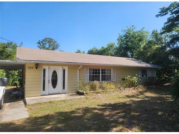 Charming front exterior view with a well-maintained lawn and inviting entrance at 5029 Eagles Nest Rd, Fruitland Park, FL 34731