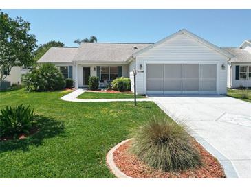 Charming single-story home with well-maintained lawn and landscaping and a screened in garage at 508 Carrera Dr, The Villages, FL 32159
