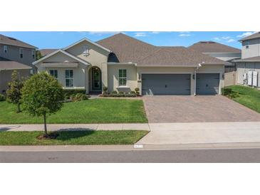 Charming single-Gathering home with lush lawn, manicured landscaping, and a two-car garage at 677 Brooks Field Dr, Winter Garden, FL 34787
