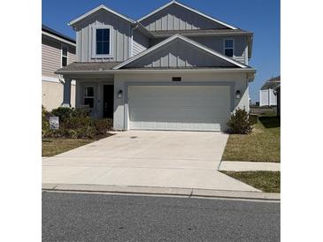 Charming two-story home with a well-maintained lawn and a two-car garage at 6846 Wilson Hammock Ave, Groveland, FL 34736