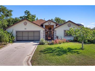 Charming single-story home with a well-manicured lawn and inviting front entrance at 21815 Tartan St, Leesburg, FL 34748