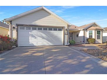 Charming single-story home featuring a spacious two-car garage and well-maintained front yard landscaping at 287 Ellenton Run, The Villages, FL 32162