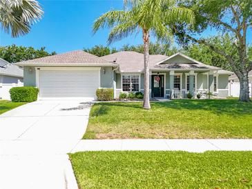 Charming single-story home featuring a well-manicured lawn and inviting curb appeal on a sunny day at 2894 Southern Pines Loop, Clermont, FL 34711