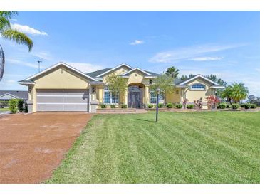 Inviting single-story home with a well-manicured lawn and a charming front entrance at 5433 County Road 125, Wildwood, FL 34785