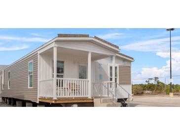 Charming manufactured home with a cozy porch and neutral siding, blending comfort and style at 811 N Swindell #2 Ave, Lakeland, FL 33810