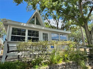 Charming home with a-frame architecture, surrounded by lush greenery and a well-maintained landscape at 10301 Us Highway 27 # 63, Clermont, FL 34711