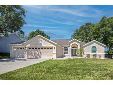 Charming single-Gathering home with a well-manicured lawn, a three-car garage and inviting curb appeal at 14421 Pine Cone Trl, Clermont, FL 34711