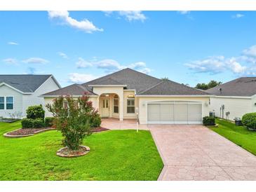 Charming single-story home boasts a well-manicured lawn and a spacious two-car garage at 2120 Callaway Dr, The Villages, FL 32162