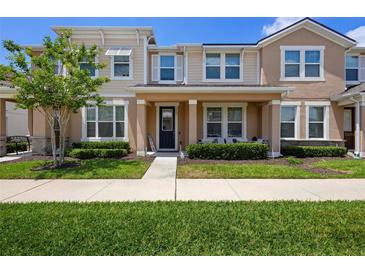 Inviting townhome showcasing well-maintained landscaping, a cozy porch, and a welcoming entryway at 2202 Garden Belle Dr, Clermont, FL 34711