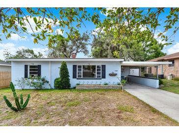 Charming single-story home featuring a well-kept front yard, covered carport, and freshly painted exterior at 2209 Hutchinson Ave, Leesburg, FL 34748
