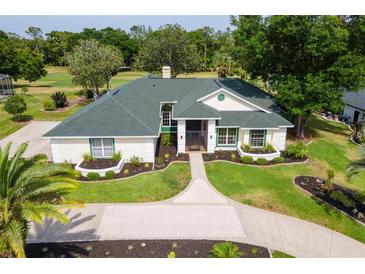 Beautiful home with a manicured lawn, landscaped garden, and a charming brick driveway at 39206 Treeline Dr, Lady Lake, FL 32159