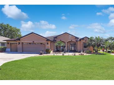 Charming single-story home with a well-manicured lawn and mature landscaping at 6104 Hunters Ridge Ave, Leesburg, FL 34748